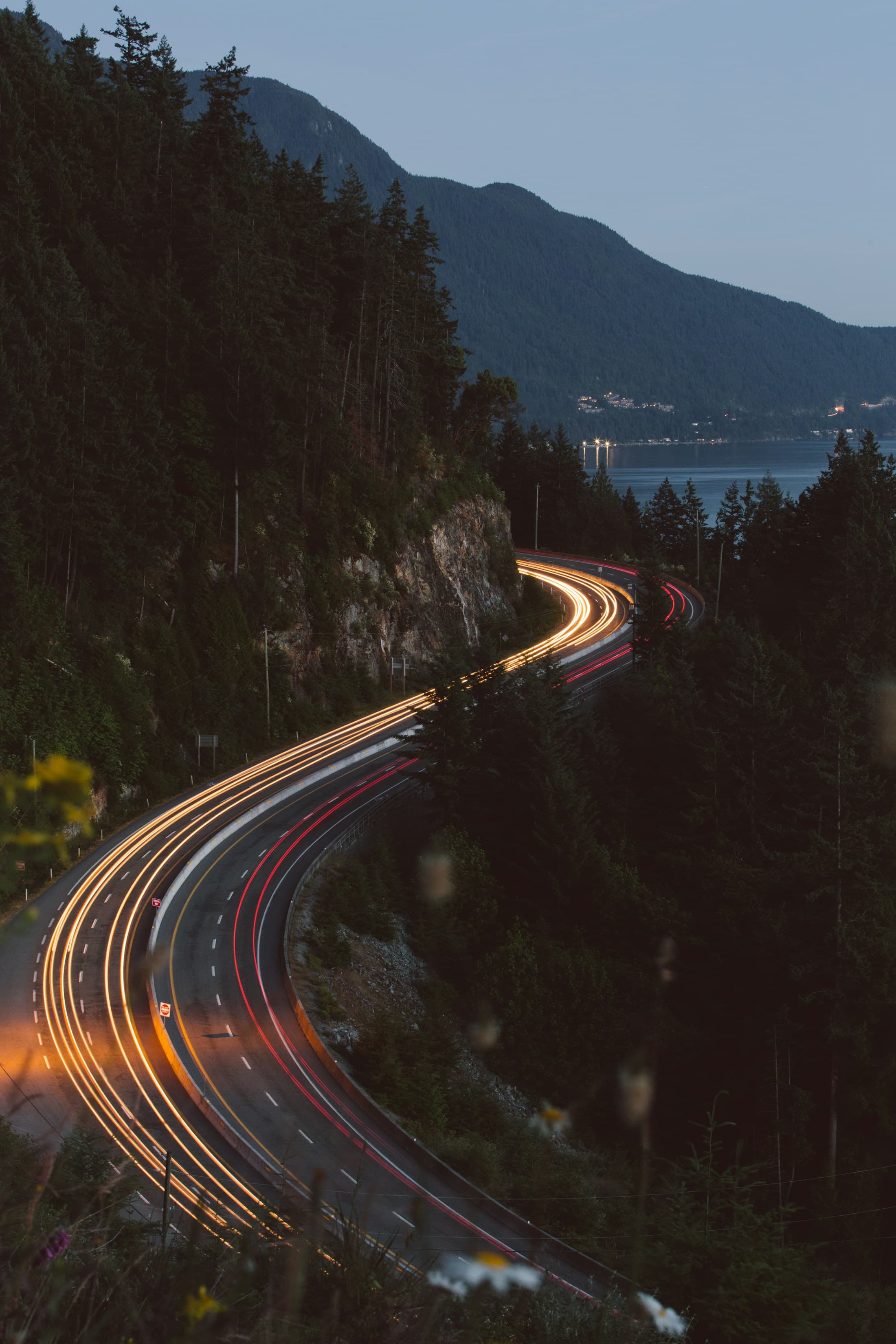 Light trails along a coastal road at dusk. Temporary Unsplash artwork.