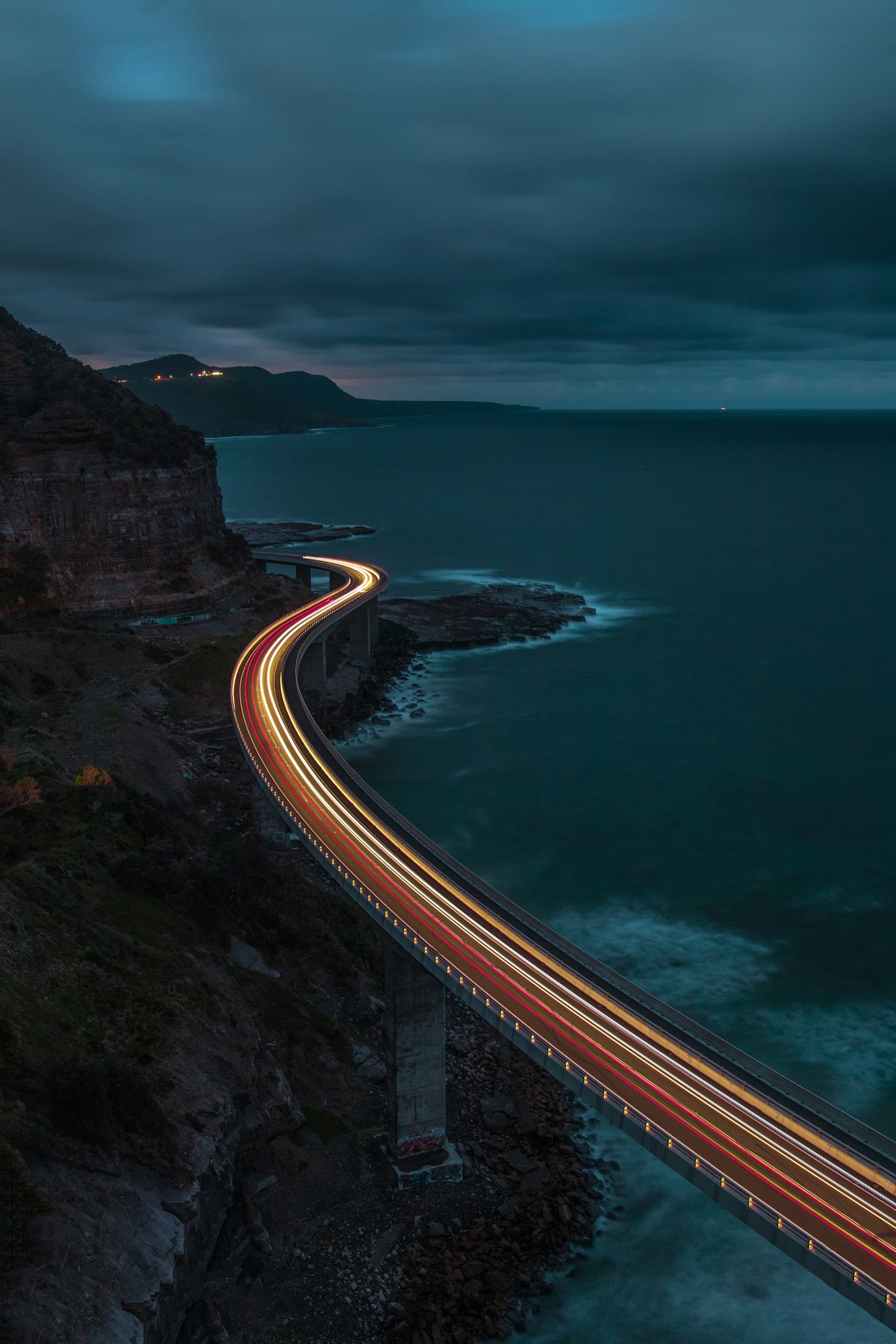 A coastal road leading to a lighthouse. Temporary Unsplash artwork.